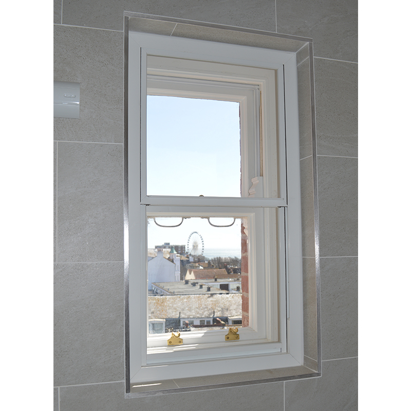 Close up of Selectaglaze secondary glazing for thermal improvement in the bathroom with views to the Brighton Eye