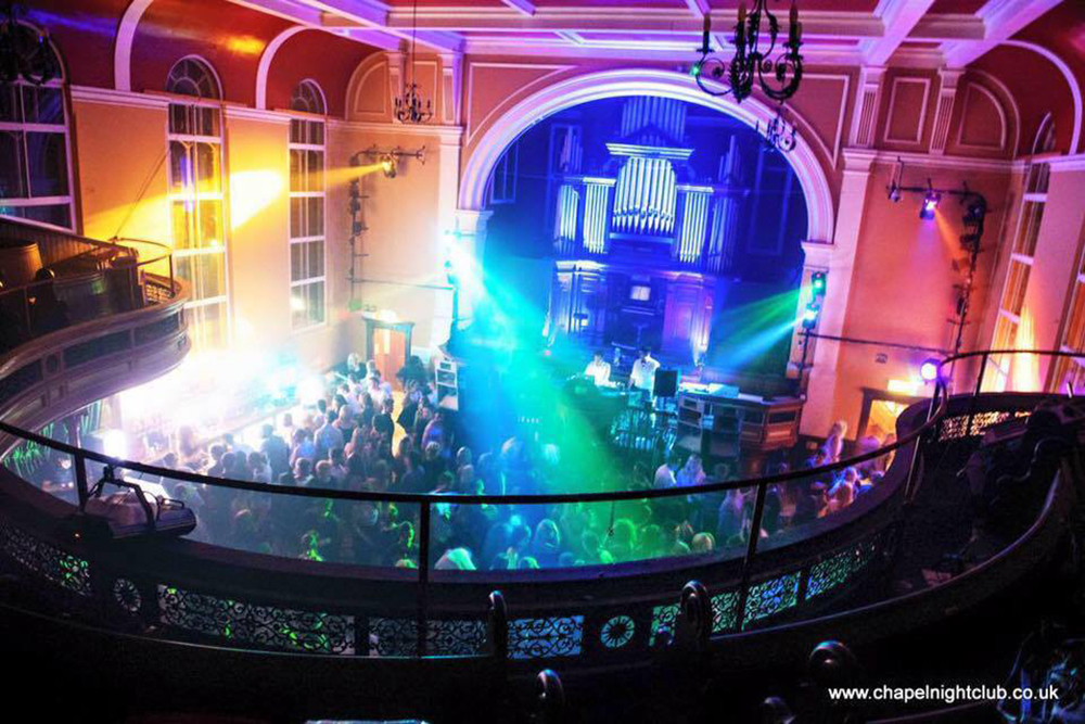 Revellers dancing in what were aisles in a chapel converted to a nightclub