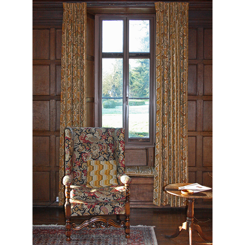 Denton House wooden panelled sitting room with colour matched brown secondary glazing