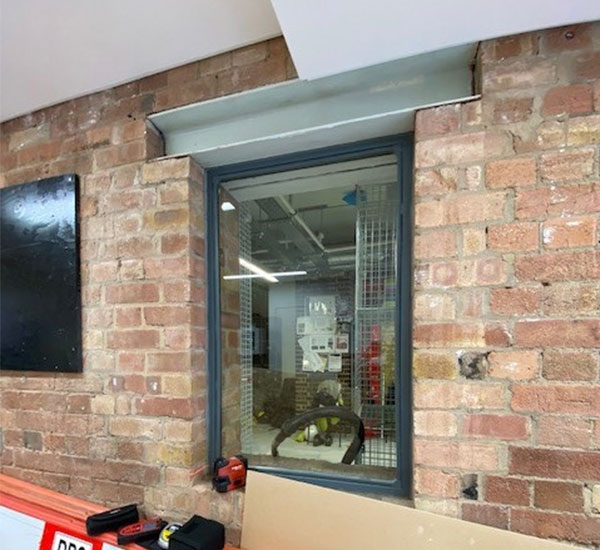 Current window to be replaced with a Series 20 secondary glazing unit in a postal hatch