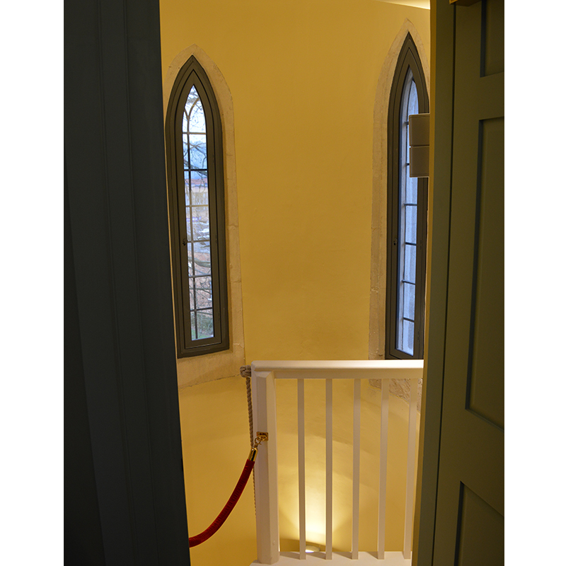 Slim high level arched secondary glazing in turrets of Grade II LIsted Gatehouse