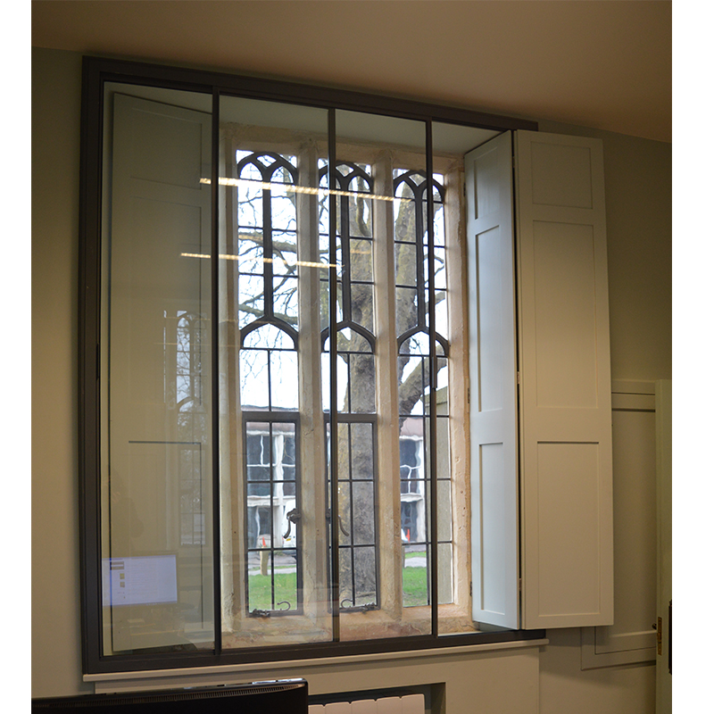 Lower lodge gatehouse with working shutters between primary and secondary glazing