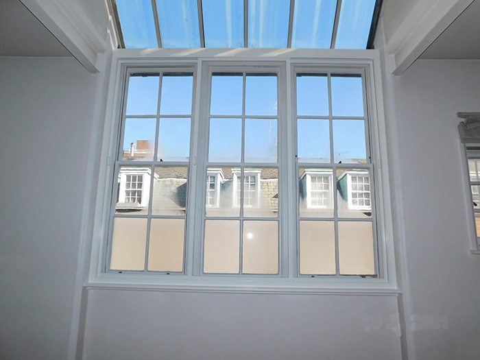 The installed Series 80 horizontal slider in front of 3 vertical sliding box sash windows.