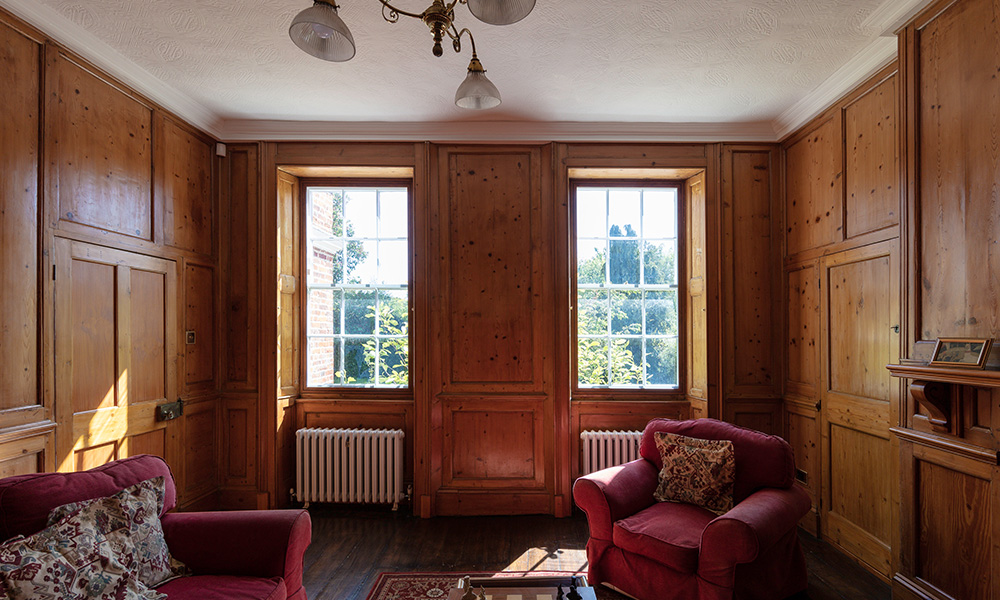 Wooden panelled room in a Listed building with secondary glazing in the windows