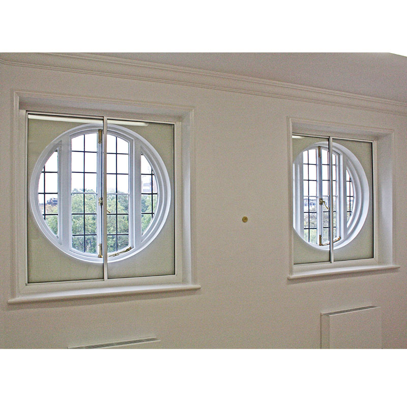 Horizontal sliding secondary treatments to original circular windows