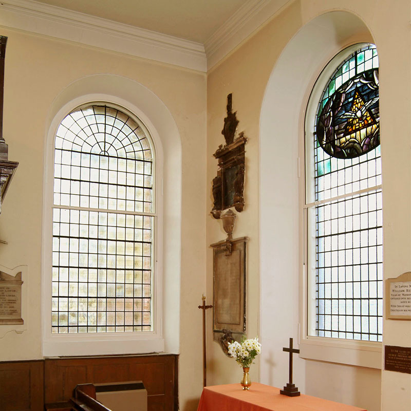 All Saints Church with arched series 90 vertical sliding secondary glazing