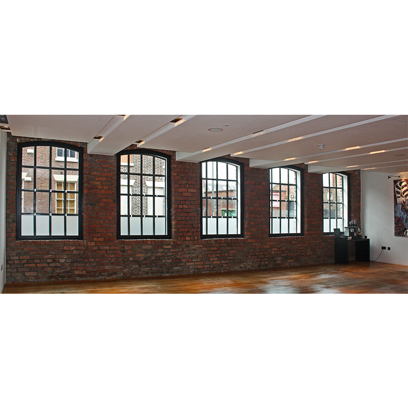 Large arched windows in the Base2Stay reception area - glazed with noise reduction secondary glazing
