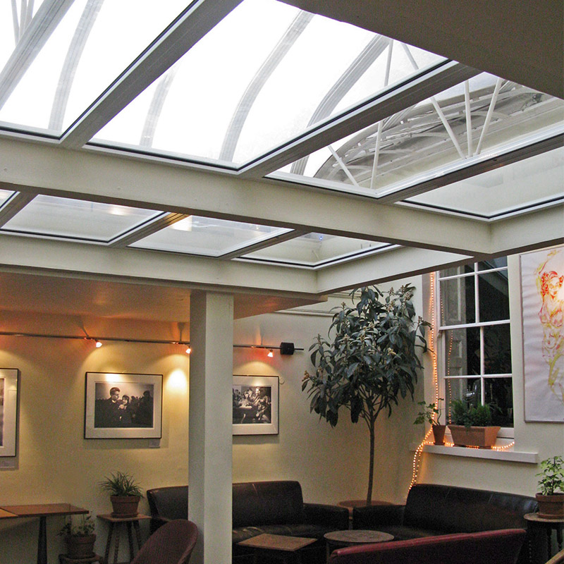 Interior lounge with roof lights treated with secondary glazing to prevent heat loss and contain the noise from the bar
