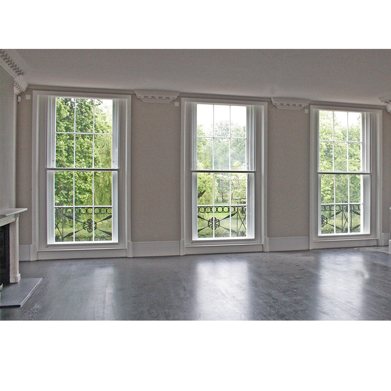 Dining Room with large vertical sliding units installed on the inside of the primary windows