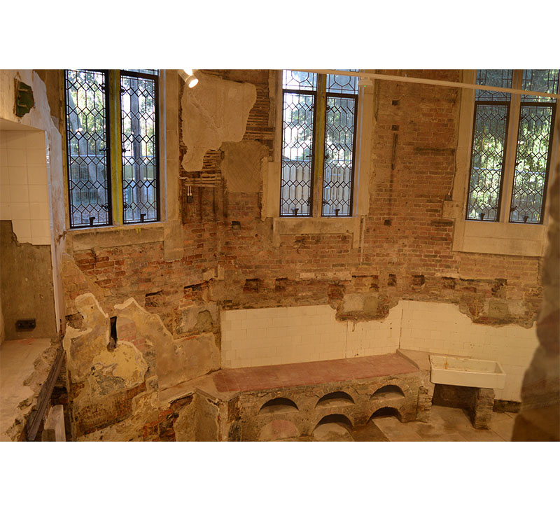 Room in highcliffe castle with stone mullions and leaded lights. Showcasing some unearthed ruins/remains under the floor