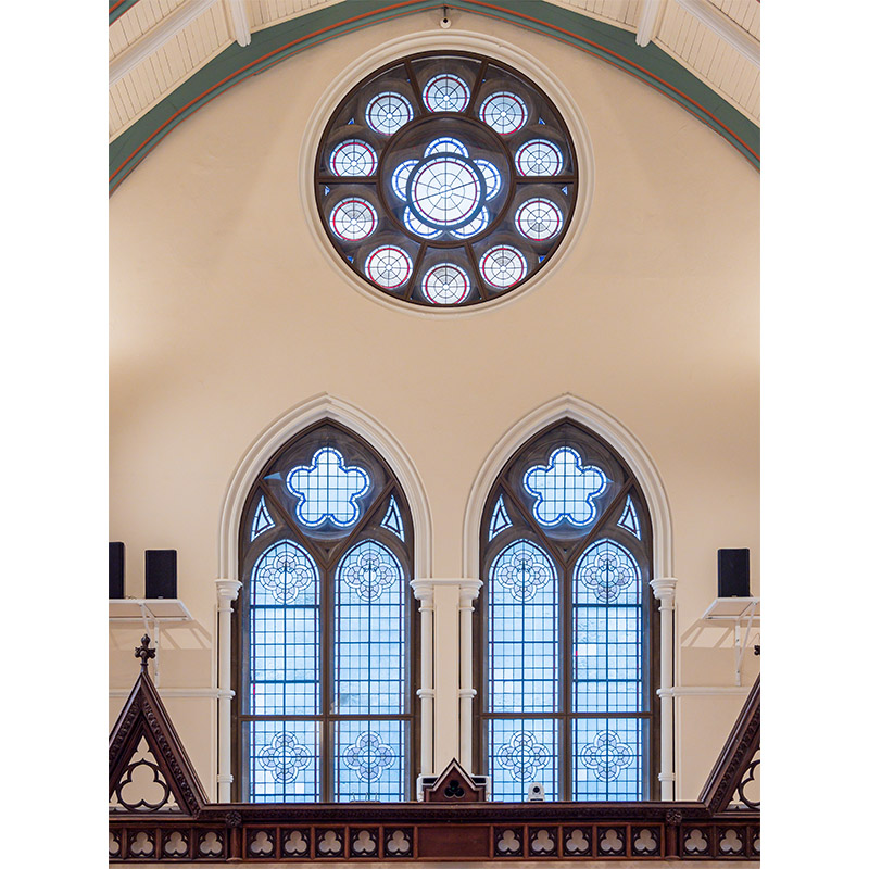 High level circular window with secondary glazing in church