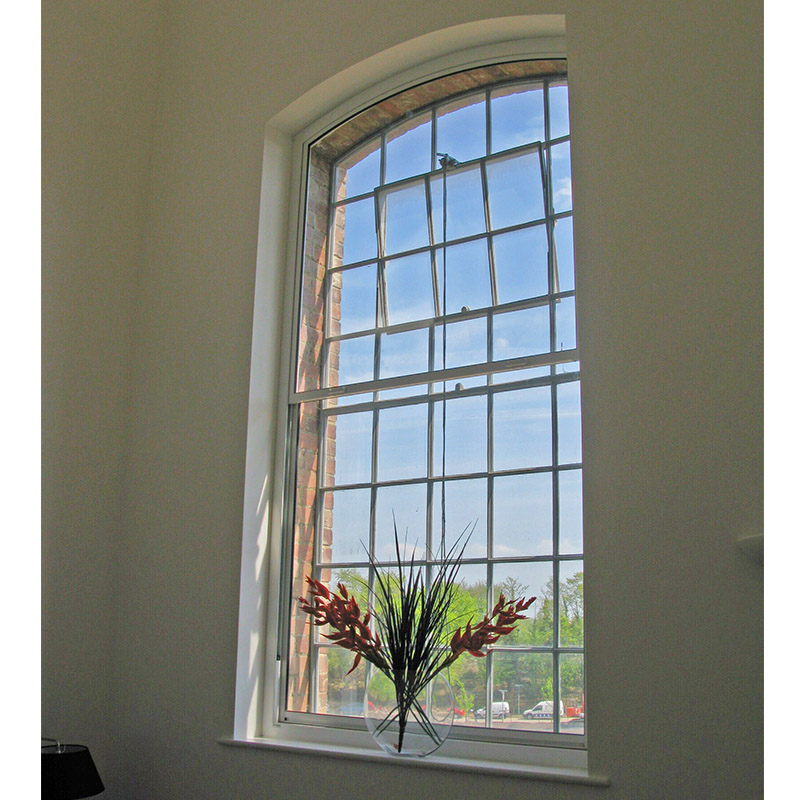 Primary window with hopper light treated with secondary glazing