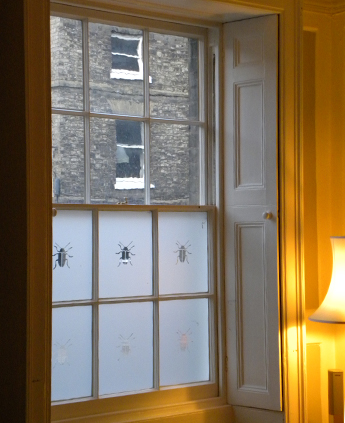 Heritage primary windows in a Listed building with shutters, needing secondary glazing