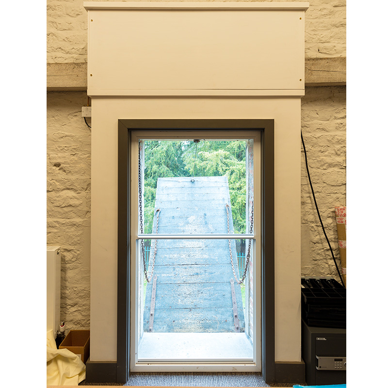 Grade I Listed Belton Stable office refurbishment with Series 20 vertical slider to an unusual original drop down door