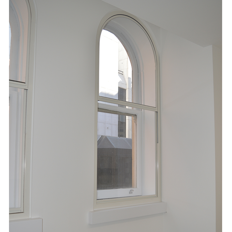 Curved head vertical sliding secondary glazing