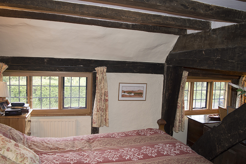 Overall room view in a Grade II Listed Building with irregularities of ceiling, but secondary glazing fitted in a squared opening due to scribed timber grounds.
