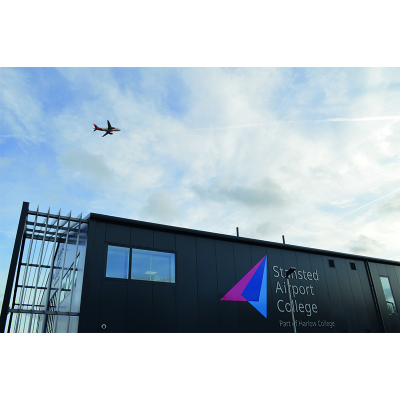 STansted Airport College exterior with overhead plane