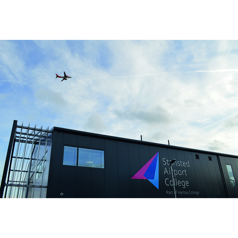 STansted Airport College exterior with overhead plane