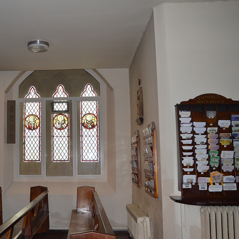Gothic arched window at St Patricks Church with Selectaglaze Series 41 side hug casements transom coupled to Series 46 curved fixed light secondary glazing for acoustic insulation