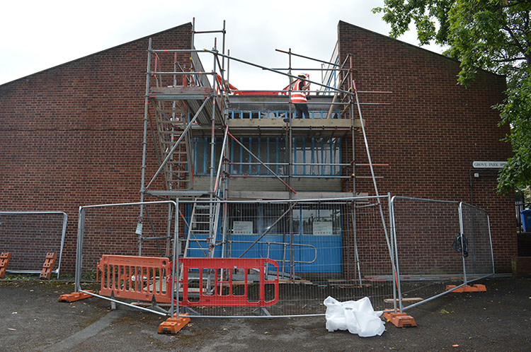 Willmott Dixon Interiors trainee challenge, repairing the windows at Grove Park Youth Club, London